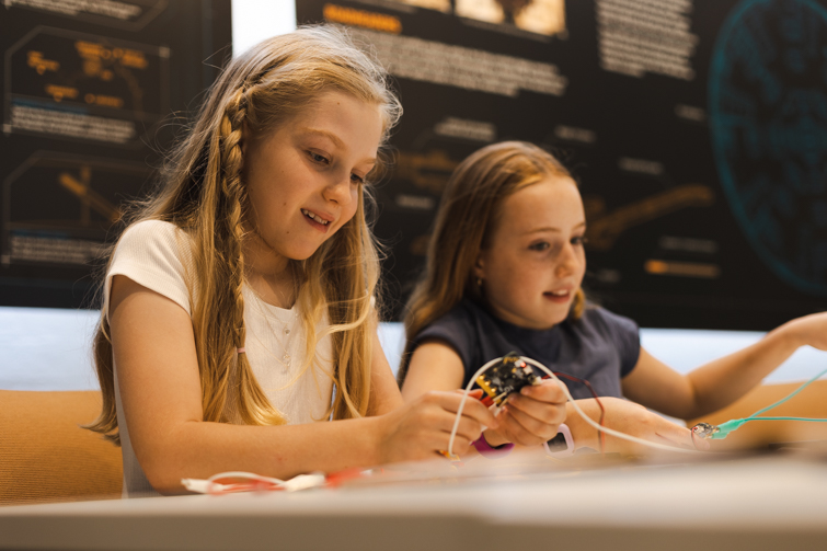 Two young kids completing activites in the Experience Centre.